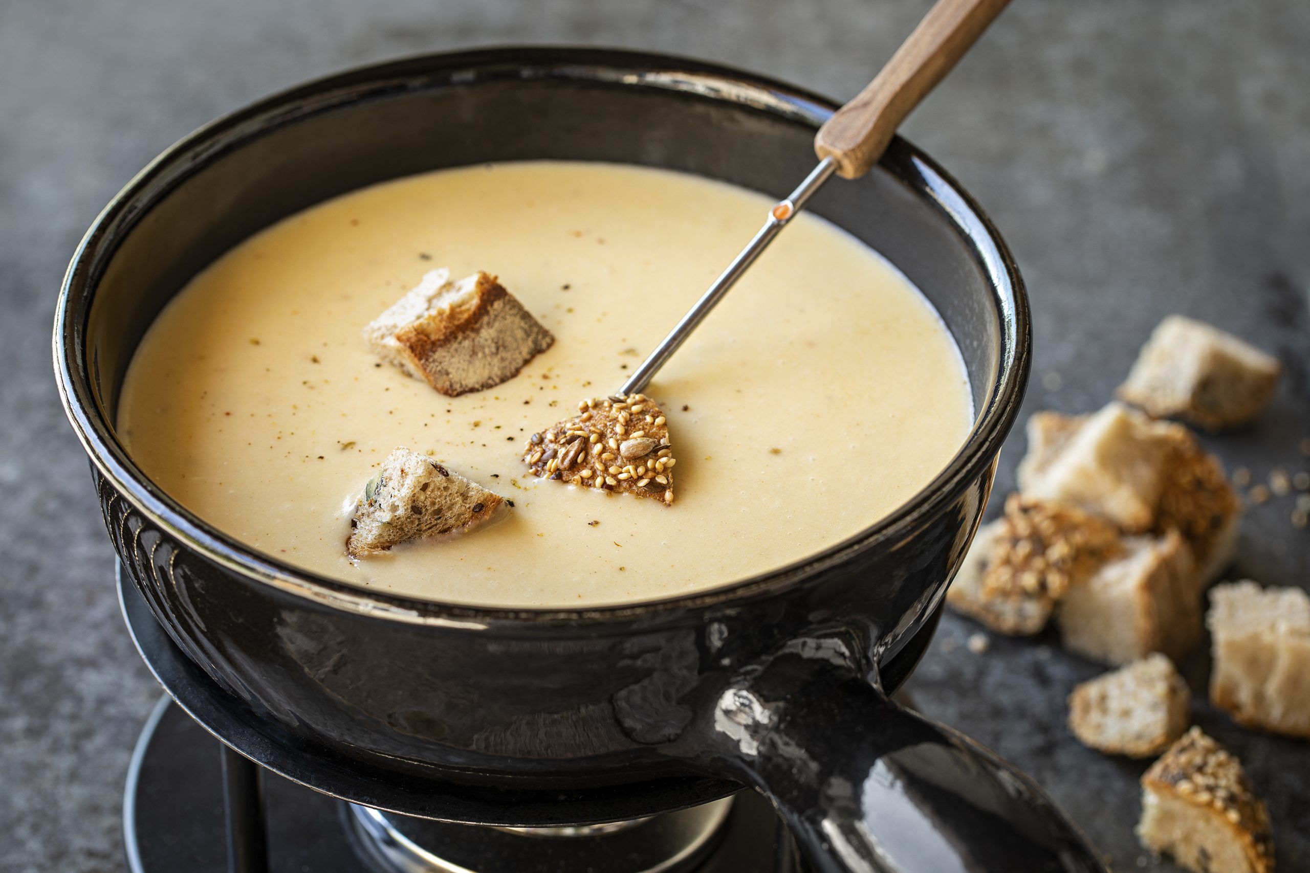 a bowl of soup with croutons on top